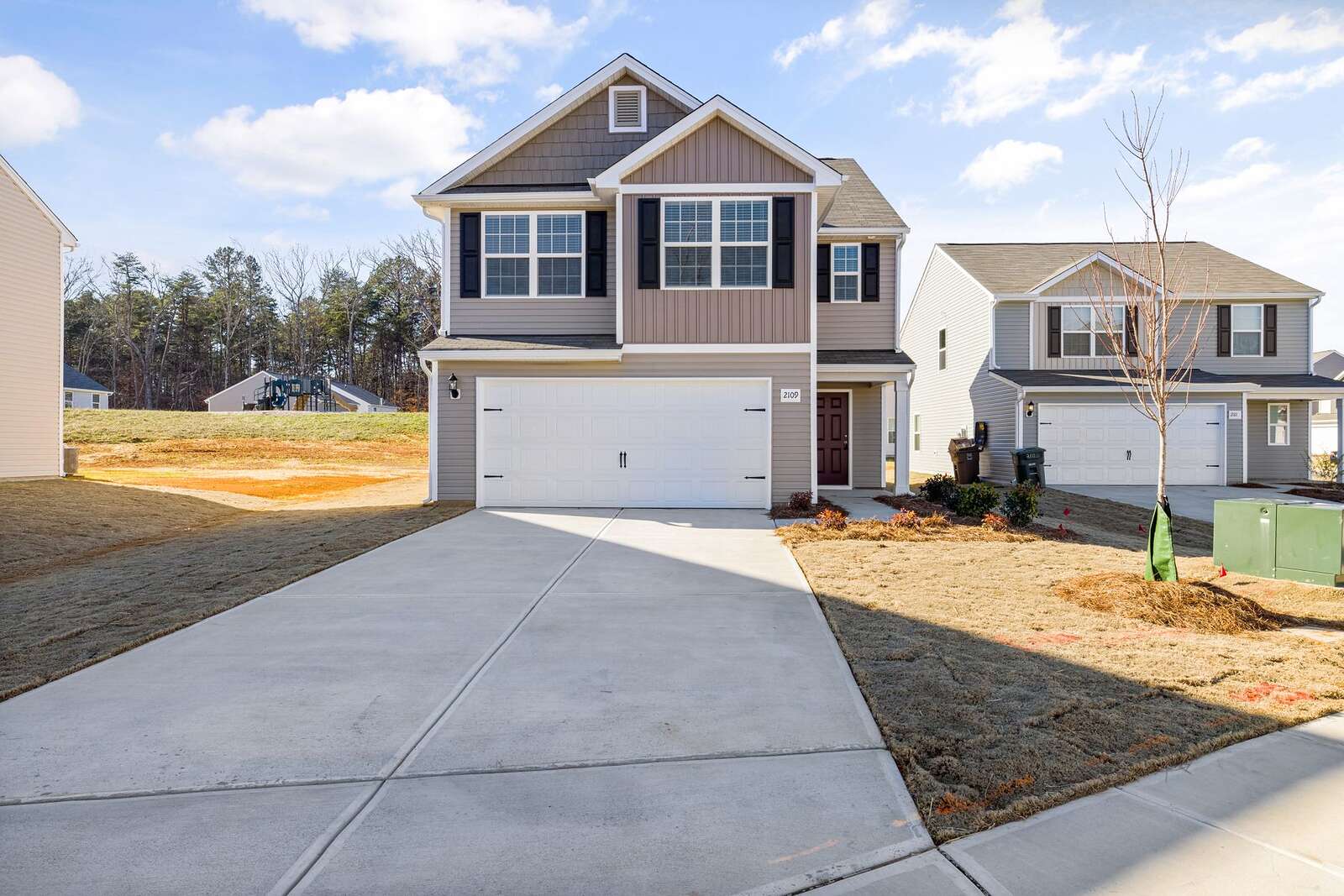 A newer two-story tract house in Natomas with a wide concrete driveway