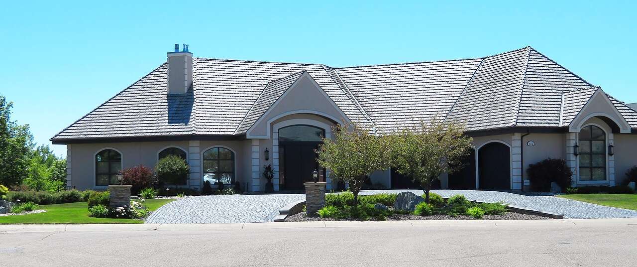 A single-story stucco house with a tile roof on an Elk Grove street